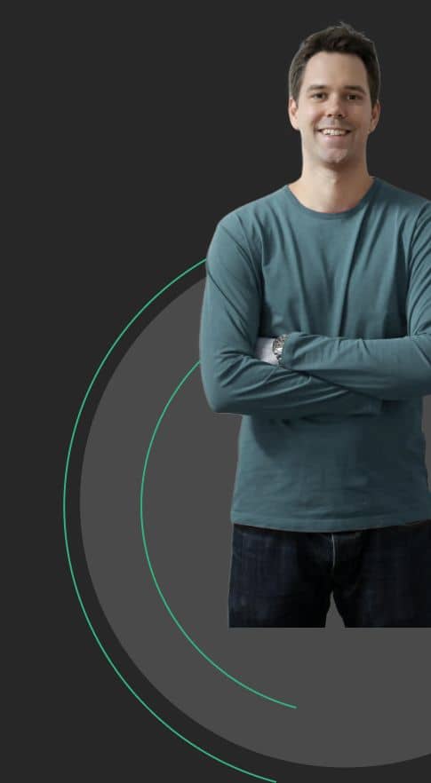 loanspot A man wearing a blue long-sleeved shirt and blue jeans stands with his arms